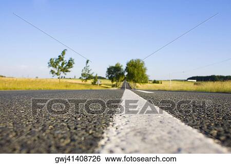 Road passing through a field, Loire Valley, France View Large Photo Image Stock Photograph - Road passing through a field, Loire Valley, France. Fotosearch