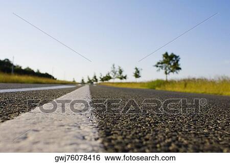 Road passing through a field, Loire Valley, France View Large Photo Image Stock Photograph - Road passing through a field, Loire Valley, France. Fotosearch