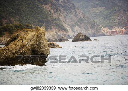 Rocks in the sea, Mar Ligure, Italian Riviera, Cinque Terre National Park, Vernazza, La Spezia, Liguria, Italy View Large Photo Image Stock Photo - Rocks in the sea, Mar Ligure, Italian Riviera, Cinque Terre National Park, Vernazza, La Spezia, Liguria, Italy. Fotosearch