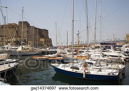 Sailboats docked at a harbor with a castle in the background, Borgo Marinaro, Castel Dell'ovo, Bay of Naples, Naples, Naples Province, Campania, Italy View Large Photo Image Stock Photo - Sailboats docked at a harbor with a castle in the background, Borgo Marinaro, Castel Dell'ovo, Bay of Naples, Naples, Naples Province, Campania, Italy. Fotosearch