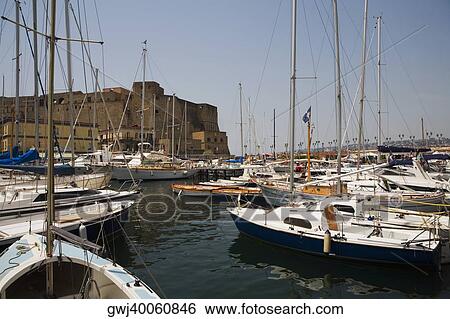 Sailboats docked at a harbor with a castle in the background, Borgo Marinaro, Castel Dell'ovo, Bay of Naples, Naples, Naples Province, Campania, Italy View Large Photo Image Stock Photograph - Sailboats docked at a harbor with a castle in the background, Borgo Marinaro, Castel Dell'ovo, Bay of Naples, Naples, Naples Province, Campania, Italy. Fotosearch