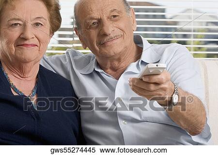 Stock Photography - Senior couple watching television. Fotosearch