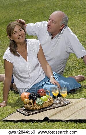 Stock Photo - Senior man adjusting the hair of a senior woman. Fotosearch