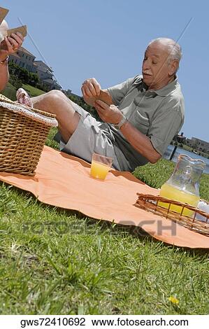 Senior man playing cards with a woman View Large Photo Image Stock Image - Senior man playing cards with a woman. Fotosearch