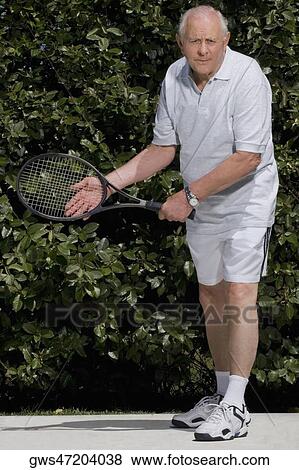 Stock Photo - Senior man playing tennis. Fotosearch