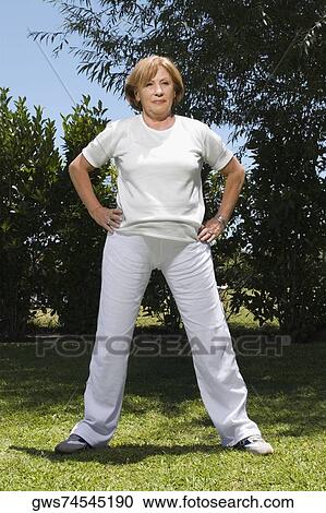 Senior woman exercising in a garden View Large Photo Image Stock Image - Senior woman exercising in a garden. Fotosearch
