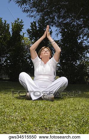 Senior woman meditating View Large Photo Image Stock Image - Senior woman meditating. Fotosearch