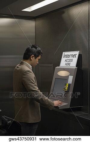 Side profile of a businessman surfing internet at an airport View Large Photo Image Stock Image - Side profile of a businessman surfing internet at an airport. Fotosearch