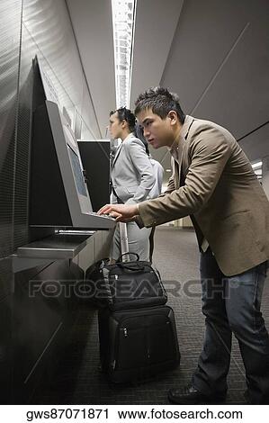 Side profile of a businessman surfing internet at an airport View Large Photo Image Stock Image - Side profile of a businessman surfing internet at an airport. Fotosearch
