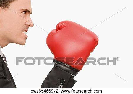 Side profile of a businessman wearing boxing gloves View Large Photo Image Stock Image - Side profile of a businessman wearing boxing gloves. Fotosearch