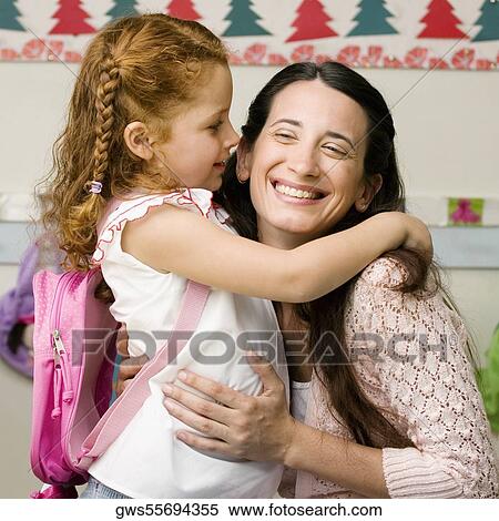Side profile of a girl whispering to her teacher View Large Photo Image Stock Photography - Side profile of a girl whispering to her teacher. Fotosearch