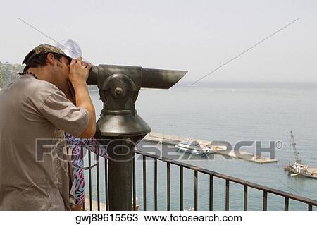 Side profile of a man looking through a coin-operated binocular, Bay of Naples, Via Aniello Califano, Sorrento, Sorrentine Peninsula, Naples Province, Campania, Italy View Large Photo Image Stock Image - Side profile of a man looking through a coin-operated binocular, Bay of Naples, Via Aniello Califano, Sorrento, Sorrentine Peninsula, Naples Province, Campania, Italy. Fotosearch