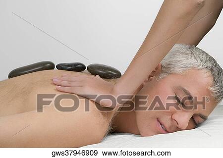 Side profile of a mature man getting a shoulder massage from a massage therapist View Large Photo Image Stock Photo - Side profile of a mature man getting a shoulder massage from a massage therapist. Fotosearch