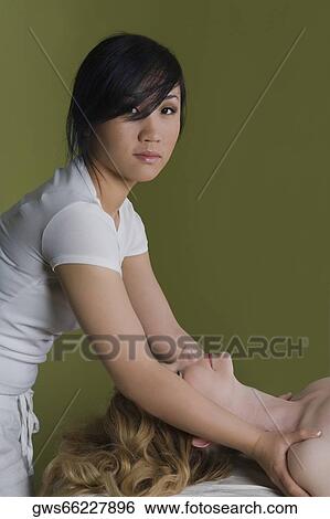Side profile of a mature woman receiving a shoulder massage from a massage therapist View Large Photo Image Stock Photograph - Side profile of a mature woman receiving a shoulder massage from a massage therapist. Fotosearch