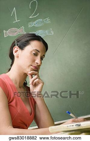 Stock Image - Side profile of a mid adult woman thinking. Fotosearch