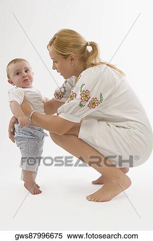 Side profile of a mid adult woman looking at her son View Large Photo Image Stock Photography - Side profile of a mid adult woman looking at her son. Fotosearch