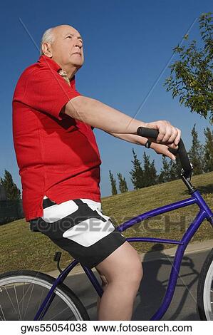 Side profile of a senior man cycling View Large Photo Image Stock Photo - Side profile of a senior man cycling. Fotosearch