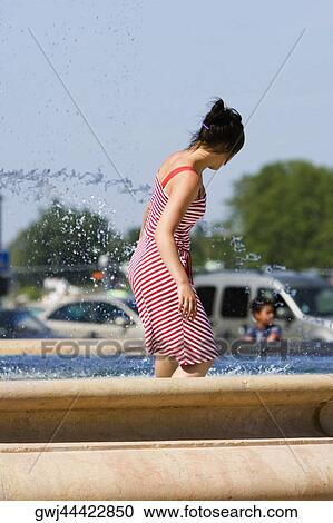 Stock Image - Side profile of a woman in a fountain, Bordeaux, Aquitaine, France. Fotosearch