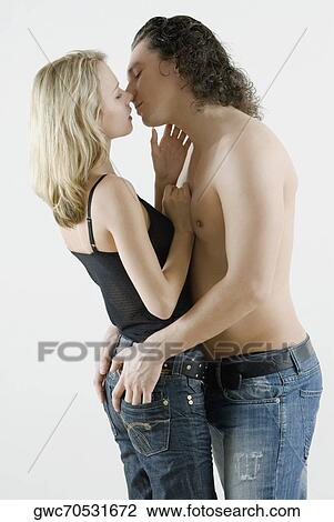 Side profile of a young couple romancing View Large Photo Image Stock Image - Side profile of a young couple romancing. Fotosearch