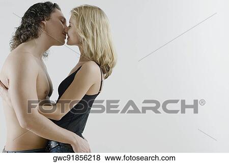 Side profile of a young couple romancing View Large Photo Image Stock Photo - Side profile of a young couple romancing. Fotosearch