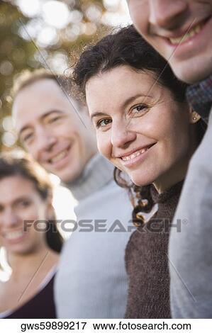 Side profile of two couples standing together and smiling View Large Photo Image Stock Photo - Side profile of two couples standing together and smiling. Fotosearch