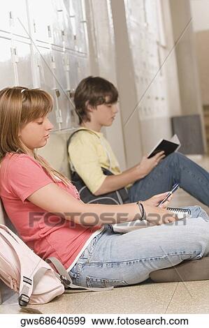 Side profile of two high school students studying in a corridor View Large Photo Image Stock Photo - Side profile of two high school students studying in a corridor. Fotosearch
