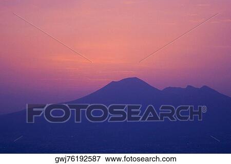 Stock Photo - Silhouette of a mountain at dusk, Mt Vesuvius, Bay of Naples, Naples, Naples Province, Campania, Italy. Fotosearch