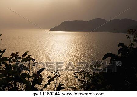 Silhouette of a mountain at the seaside, Italian Riviera, Cinque Terre National Park, Mar Ligure, Cinque Terre, La Spezia, Liguria, Italy View Large Photo Image Picture - Silhouette of a mountain at the seaside, Italian Riviera, Cinque Terre National Park, Mar Ligure, Cinque Terre, La Spezia, Liguria, Italy. Fotosearch