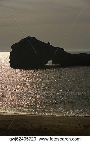 Silhouette of rock formations in the sea, Biarritz, France View Large Photo Image Stock Image - Silhouette of rock formations in the sea, Biarritz, France. Fotosearch