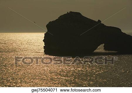 Silhouette of rock formations in the sea, Biarritz, France View Large Photo Image Stock Image - Silhouette of rock formations in the sea, Biarritz, France. Fotosearch