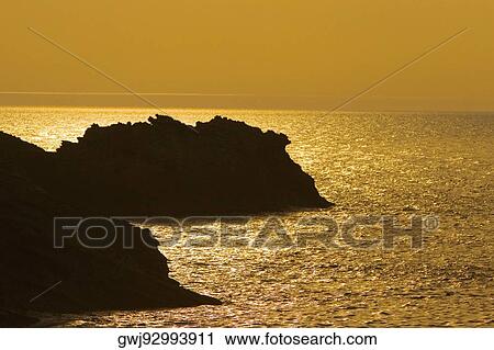 Silhouette of rock formations in the sea at dusk, Biarritz, Basque Country, Pyrenees-Atlantiques, Aquitaine, France View Large Photo Image Stock Image - Silhouette of rock formations in the sea at dusk, Biarritz, Basque Country, Pyrenees-Atlantiques, Aquitaine, France. Fotosearch