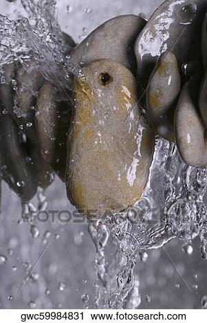 Stack of pebbles in water View Large Photo Image Stock Image - Stack of pebbles in water. Fotosearch