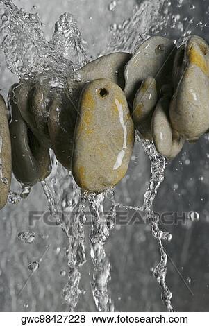 Stock Photo - Stack of pebbles in water. Fotosearch