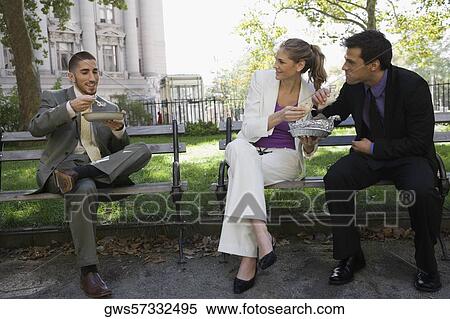 Three business executives eating food on park benches View Large Photo Image Stock Photography - Three business executives eating food on park benches. Fotosearch