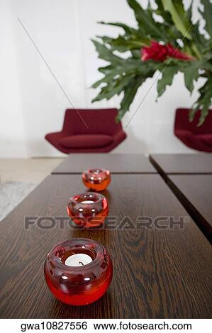 Three candles on a table View Large Photo Image Stock Photograph - Three candles on a table. Fotosearch
