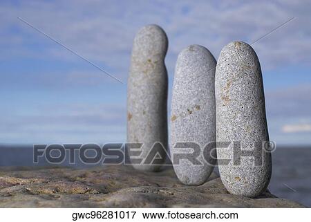 Three pebbles on a rock View Large Photo Image Stock Photo - Three pebbles on a rock. Fotosearch