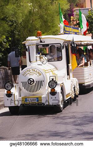 Tourist in a conch tour train, Sorrento, Sorrentine Peninsula, Naples Province, Campania, Italy View Large Photo Image Stock Photograph - Tourist in a conch tour train, Sorrento, Sorrentine Peninsula, Naples Province, Campania, Italy. Fotosearch