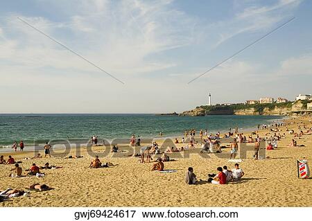 Tourists on the beach, Grande Plage, Phare de Biarritz, Biarritz, France View Large Photo Image Stock Photo - Tourists on the beach, Grande Plage, Phare de Biarritz, Biarritz, France. Fotosearch
