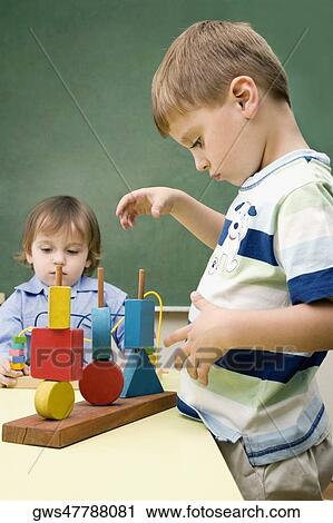 Two boys playing with toys View Large Photo Image Stock Image - Two boys playing with toys. Fotosearch