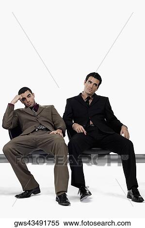Two businessmen sitting on a bench and looking stressed View Large Photo Image Stock Photography - Two businessmen sitting on a bench and looking stressed. Fotosearch