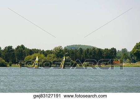 Two sailboats in a lake, Bordeaux Lake, Bordeaux, Aquitaine, France View Large Photo Image Stock Image - Two sailboats in a lake, Bordeaux Lake, Bordeaux, Aquitaine, France. Fotosearch
