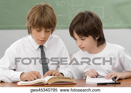 Stock Photography - Two schoolboys studying in a classroom. Fotosearch