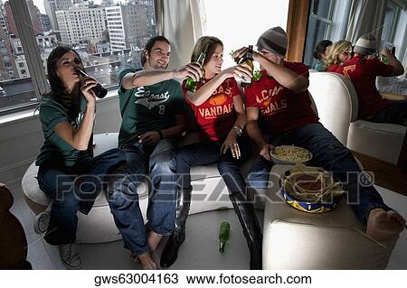 Two young couples enjoying beer View Large Photo Image Stock Image - Two young couples enjoying beer. Fotosearch