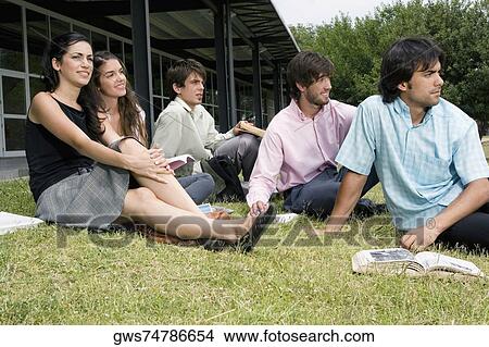 University students sitting in a lawn View Large Photo Image Picture - University students sitting in a lawn. Fotosearch