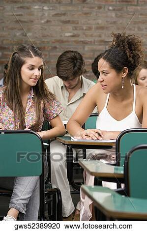 Stock Image - University students studying in a classroom. Fotosearch