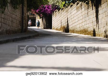 Woman walking in a street, Sorrento, Sorrentine Peninsula, Naples Province, Campania, Italy View Large Photo Image Stock Image - Woman walking in a street, Sorrento, Sorrentine Peninsula, Naples Province, Campania, Italy. Fotosearch