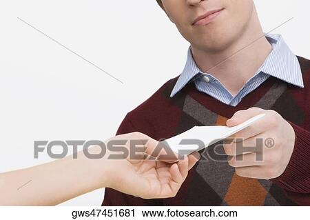 Stock Image - Young man giving a paper to a women. Fotosearch