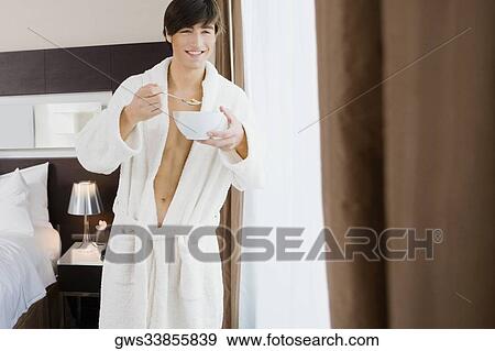 Stock Photo - Young man having food. Fotosearch
