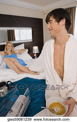 Young man holding a young woman's leg on the bed View Large Photo Image Stock Photo - Young man holding a young woman's leg on the bed. Fotosearch