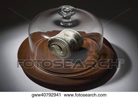 Bundle of dollar bills covered with a glass jar View Large Photo Image Stock Image - Bundle of dollar bills covered with a glass jar. Fotosearch